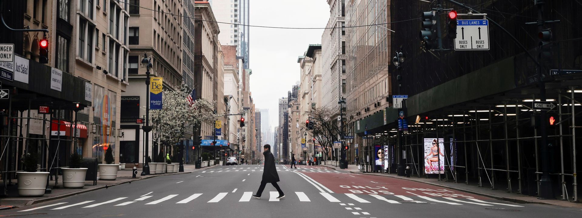 A man crosses a nearly empty 5th Avenue in midtown Manhattan during the outbreak of the coronavirus disease (COVID-19) in New York City, March 25, 2020. (Source: Medium / REUTERS/Mike Segar)